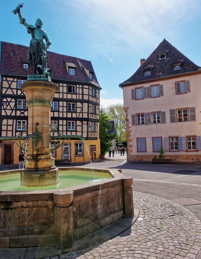 old-city-center-and-schwendi-fountain-at-place-de-ancienne-douane-square-in-colmar-haut-rhin-in-alsace-in-france-people-on-the-background